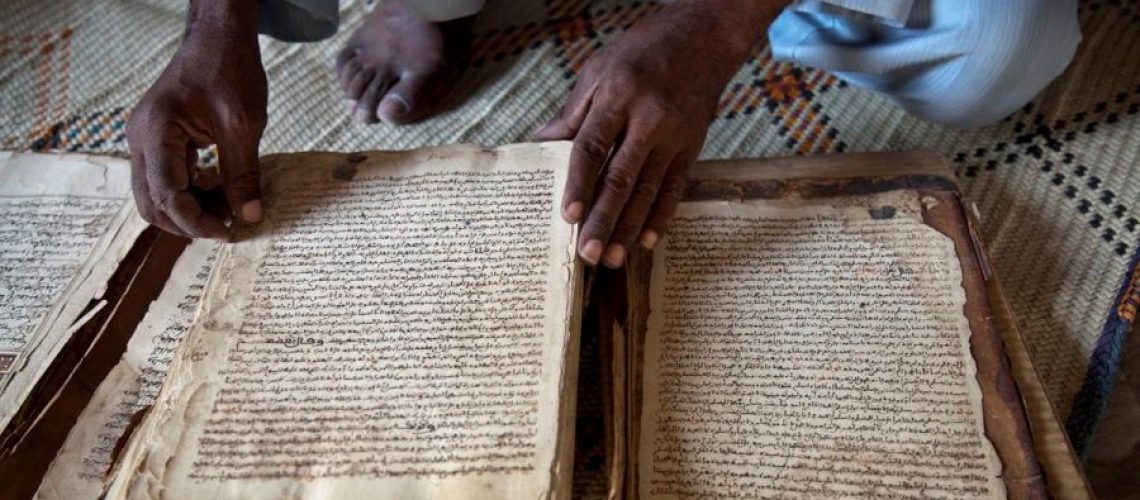 Timbuktu, December 05, 2013 - Abdul Wahid shows a manuscript from 14th century at his house in Timbuktu, North of Mali. 4203 manuscripts were destroyed by jihadists during the occupation. Many were hidden and saved at the Institut des Hautes Etudes et de Recherche Islamiques Ahmed Baba or by owners like Abdul Wahid, a koranic school teacher, who hide manuscripts that hid grand father left to him. Photo MINUSMA/Marco Dormino